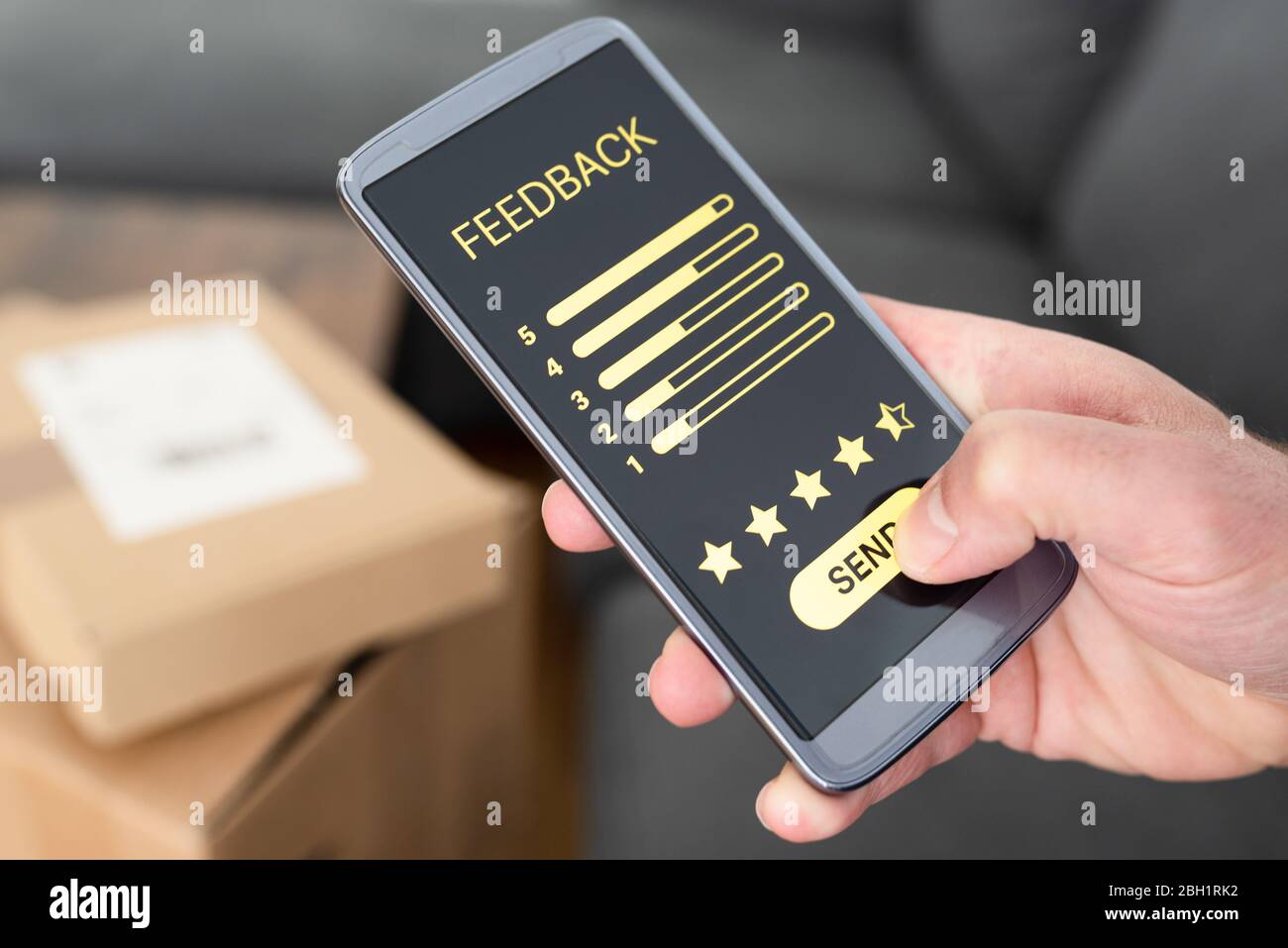 close-up of person giving positive feedback on smartphone after delivery of ordered items, customer review and feedback concept Stock Photo