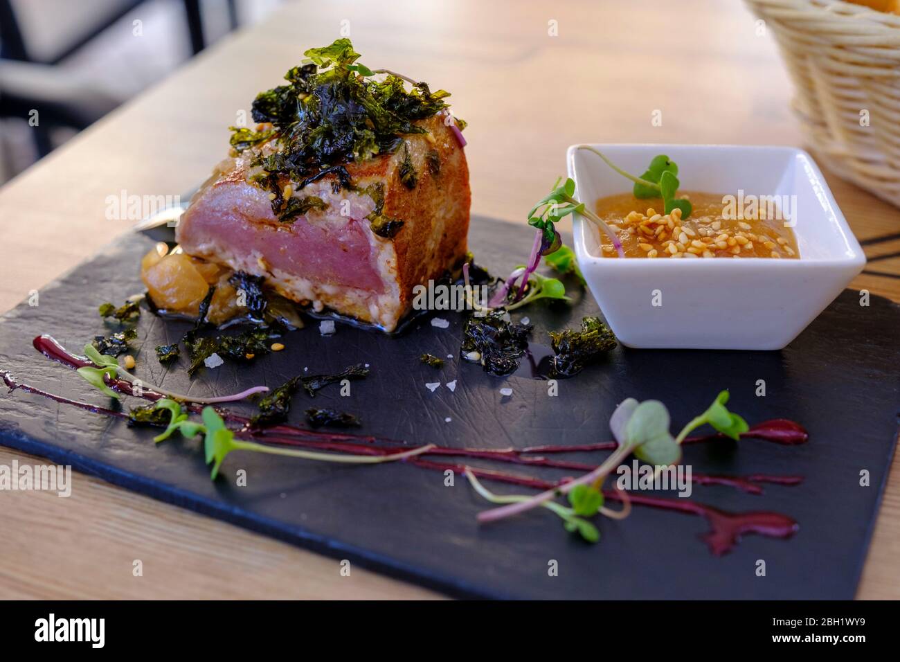 Spain, Place mat with ready-to-eat meat and bowl of dipping sauce Stock Photo