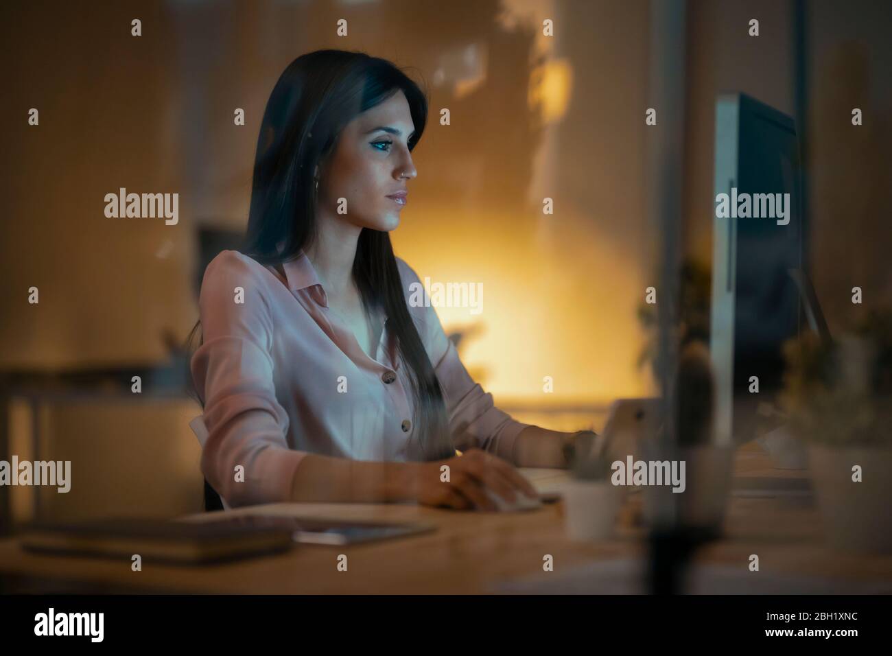 Young woman working at desk in office Stock Photo