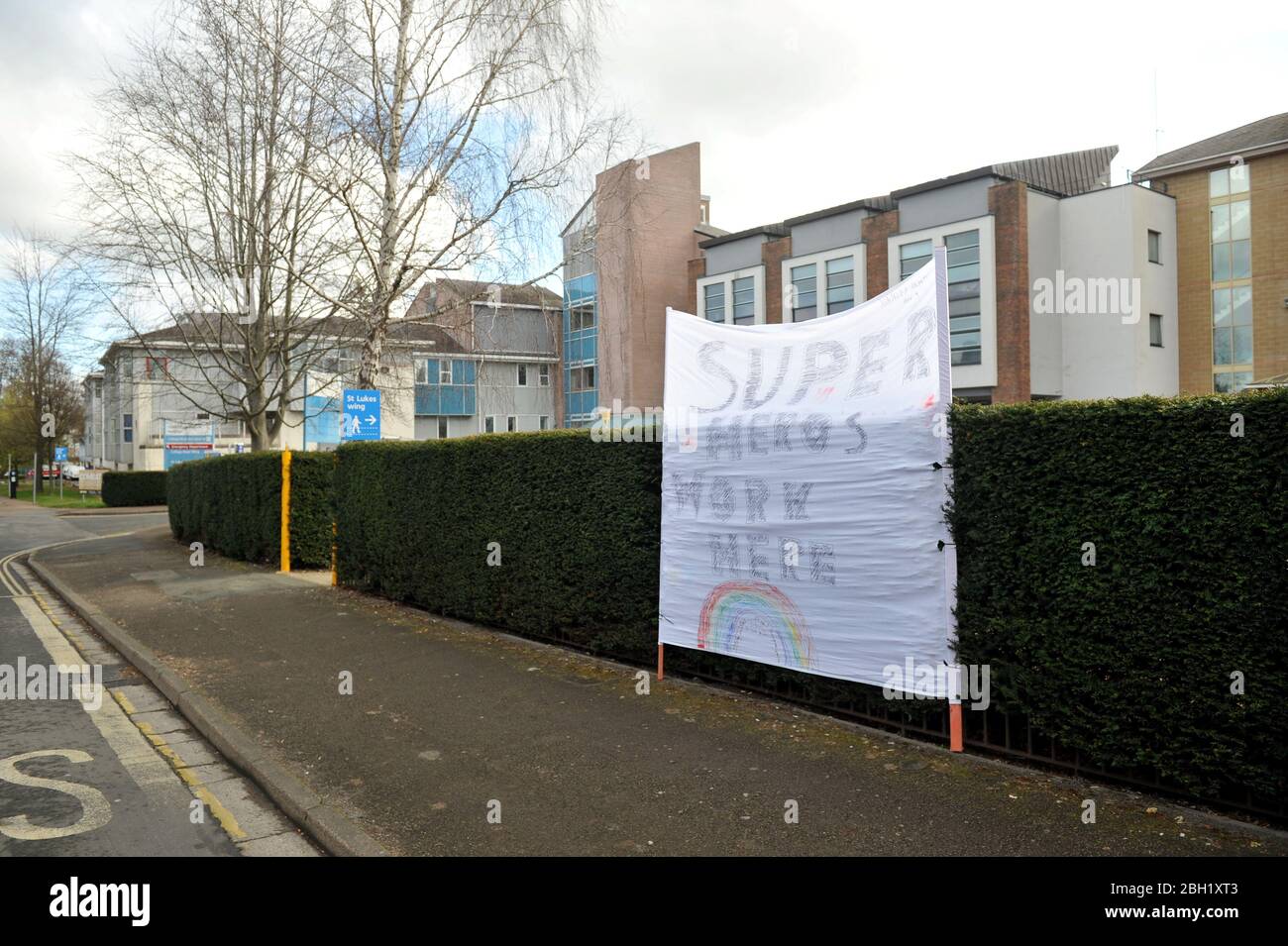 In the midst of the coronavirus pandemic a huge home-made sign has appeared outside Cheltenham General Hospital saying 'Superheroes work here' Stock Photo