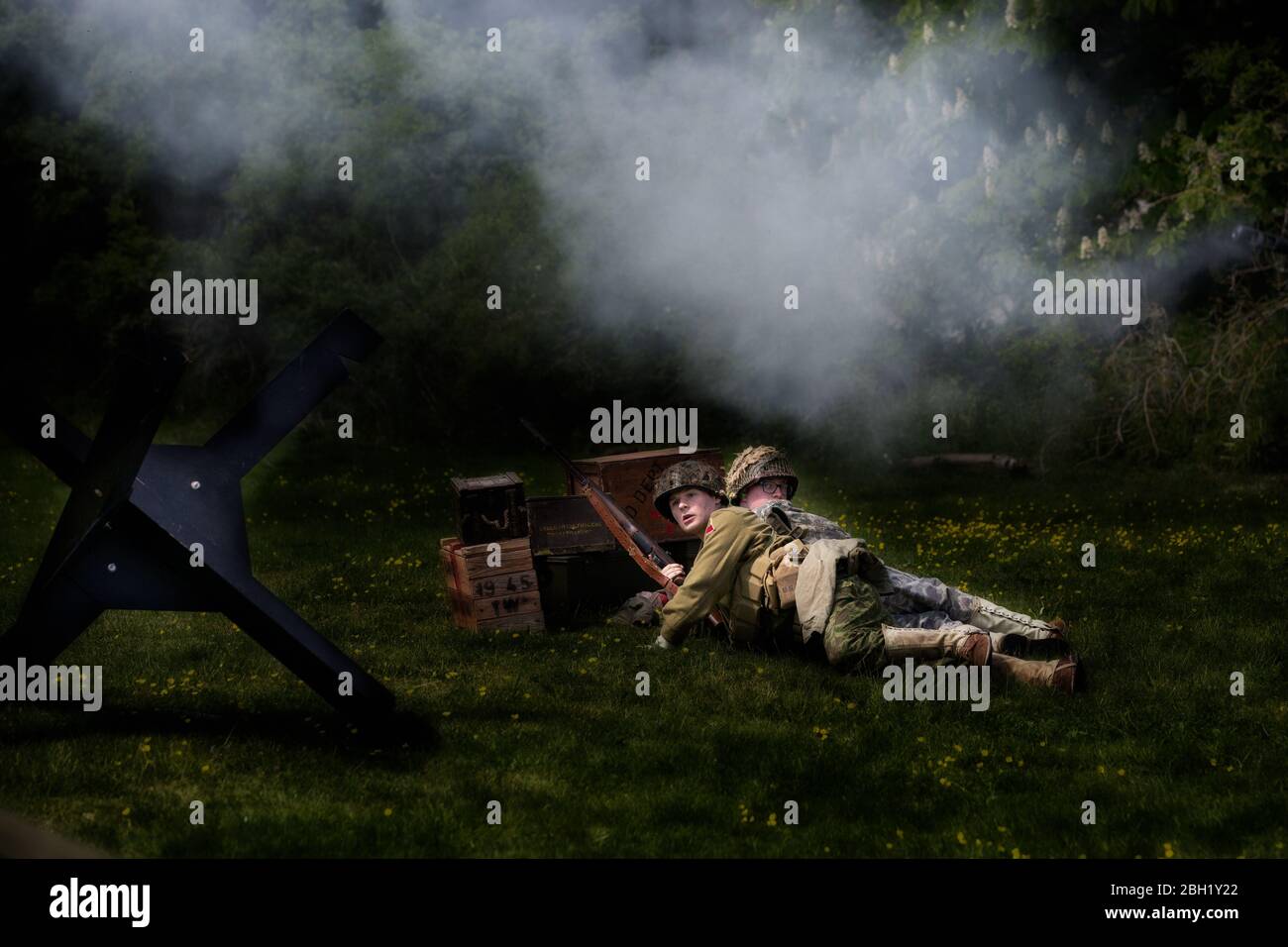 WW2 soldiers on the battlefield reenacting battle scenes with guns and ...