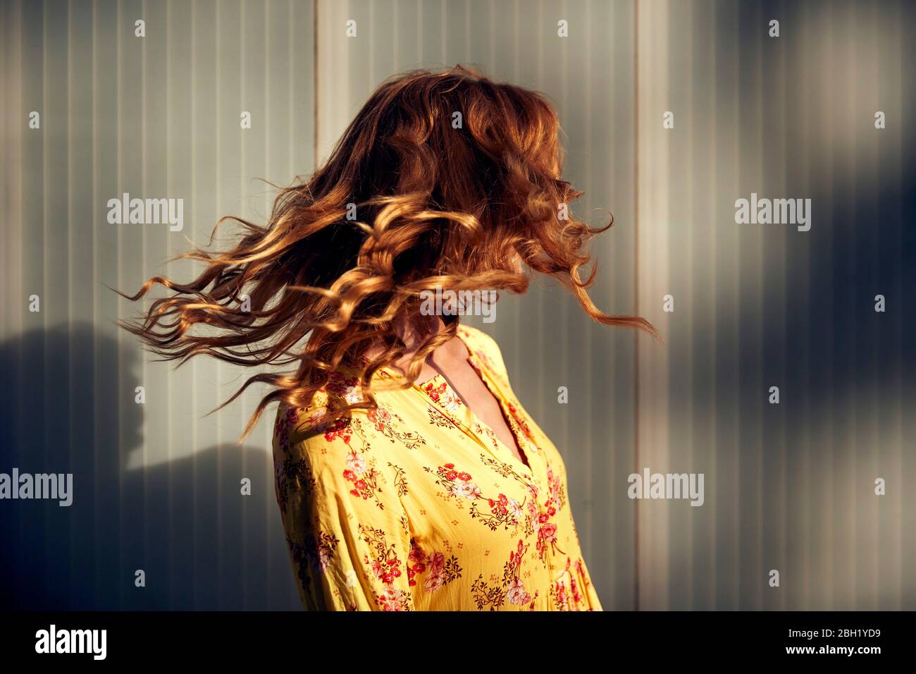 Red-haired woman shaking her hair Stock Photo