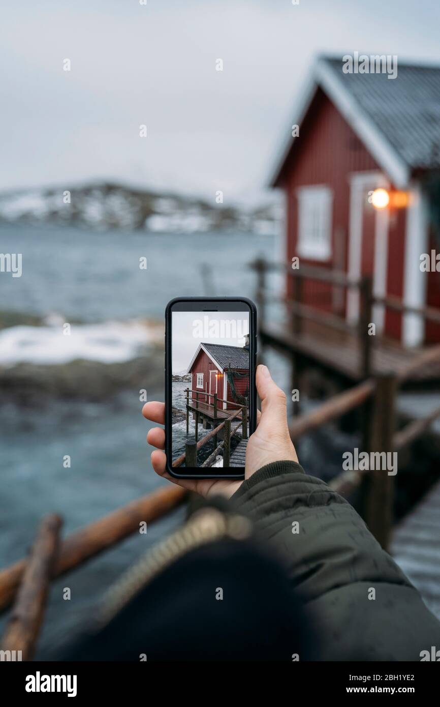 Close up tourist taking cell phone picture the coast hires stock