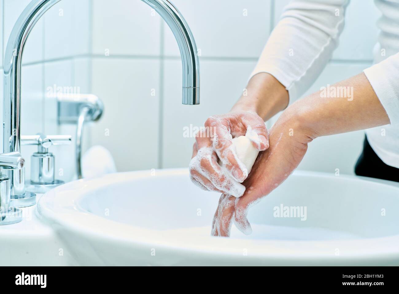 Woman washing her hand with soap Stock Photo - Alamy