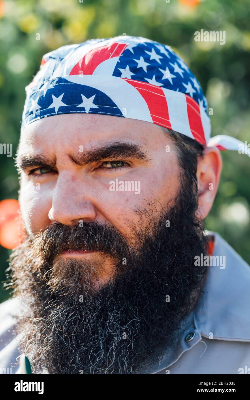 Portrait of bearded man wearing Stars and Stripes headgear Stock Photo