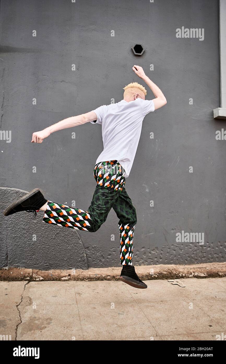 Albino man jumping in the air Stock Photo