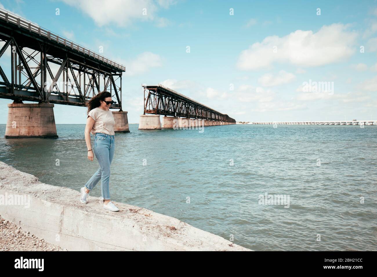 Woman walking in front of Bahia Honda Rail Bridge, Florida Keys, USA Stock Photo