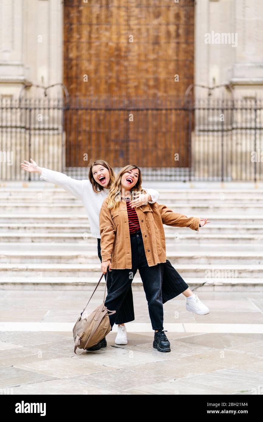 Two happy young women posing in the city Stock Photo