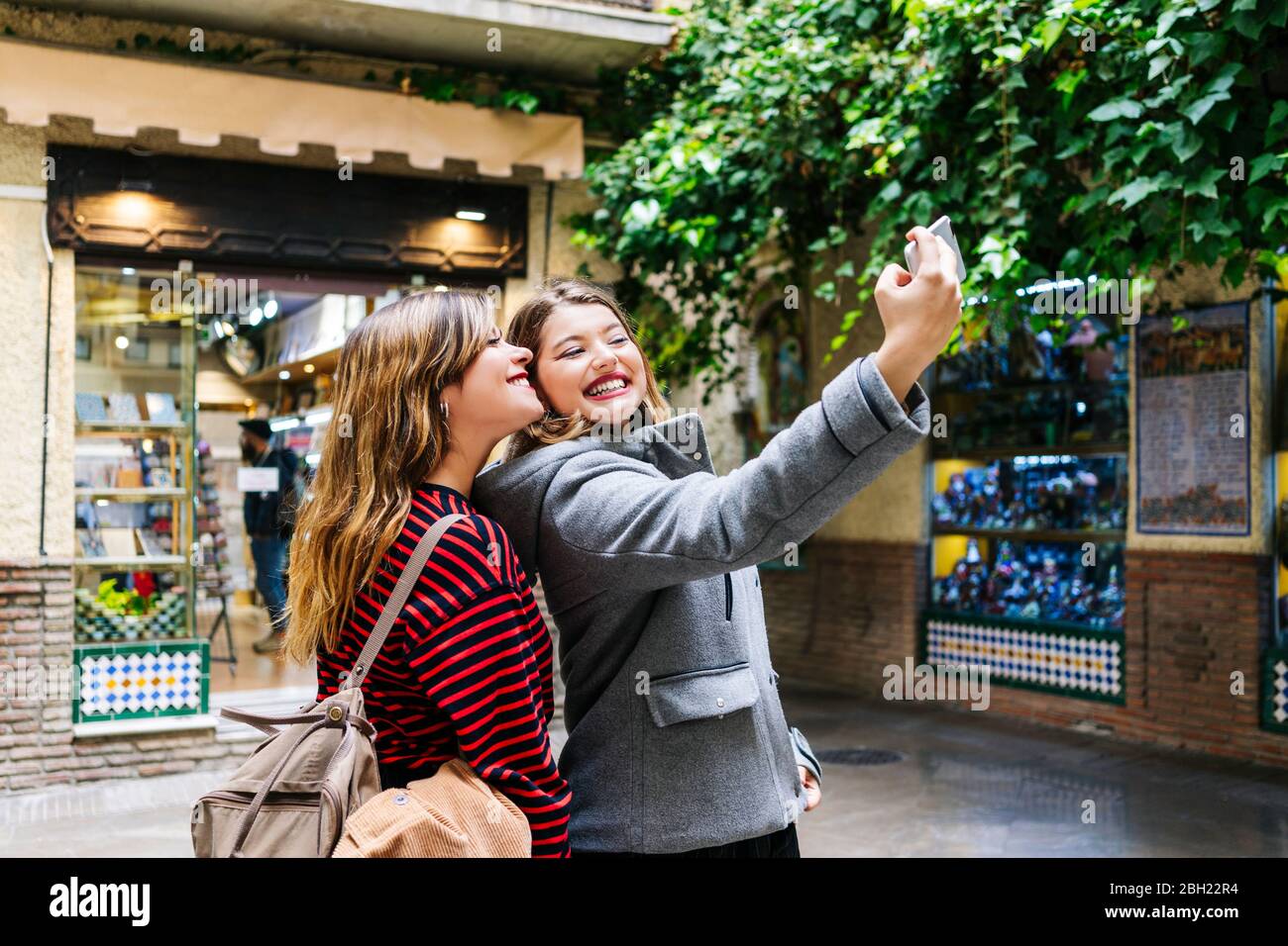 Two happy young women taking a selfie in the city Stock Photo - Alamy