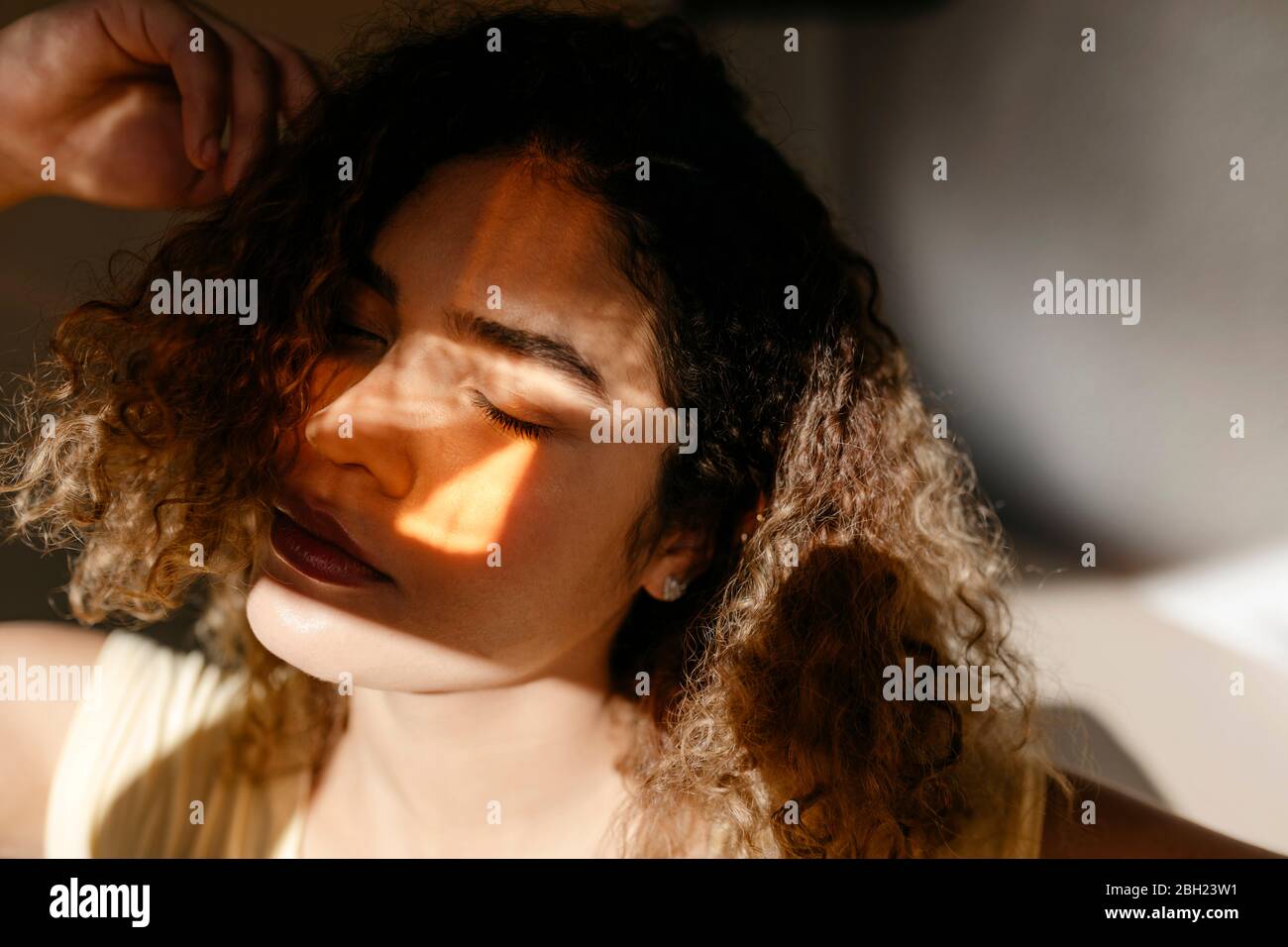 Portrait of attractive young woman with closed eyes in sunlight Stock ...