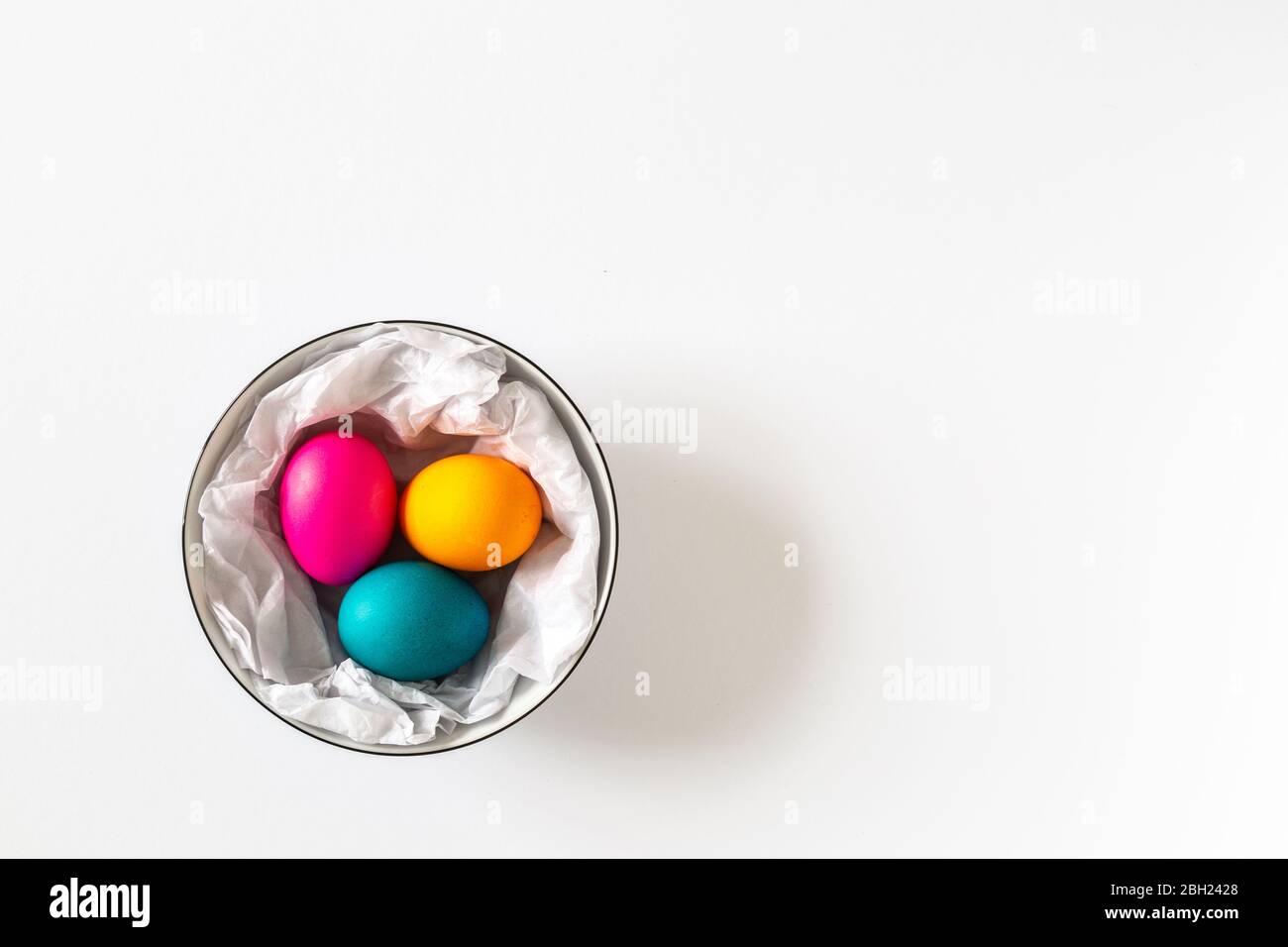 Three dyed Easter eggs in a bowl on white bachground Stock Photo