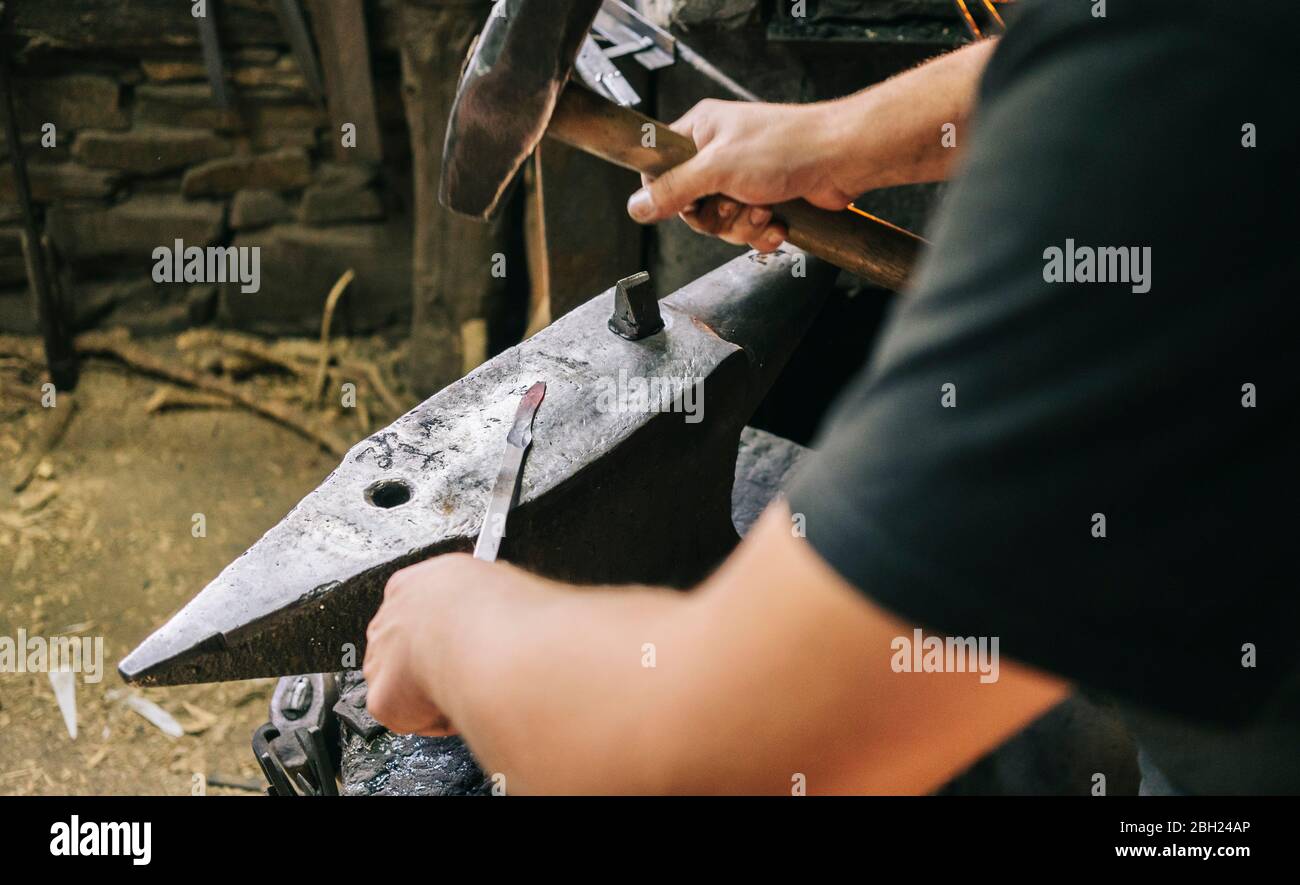 Blacksmith at work in his workshop Stock Photo