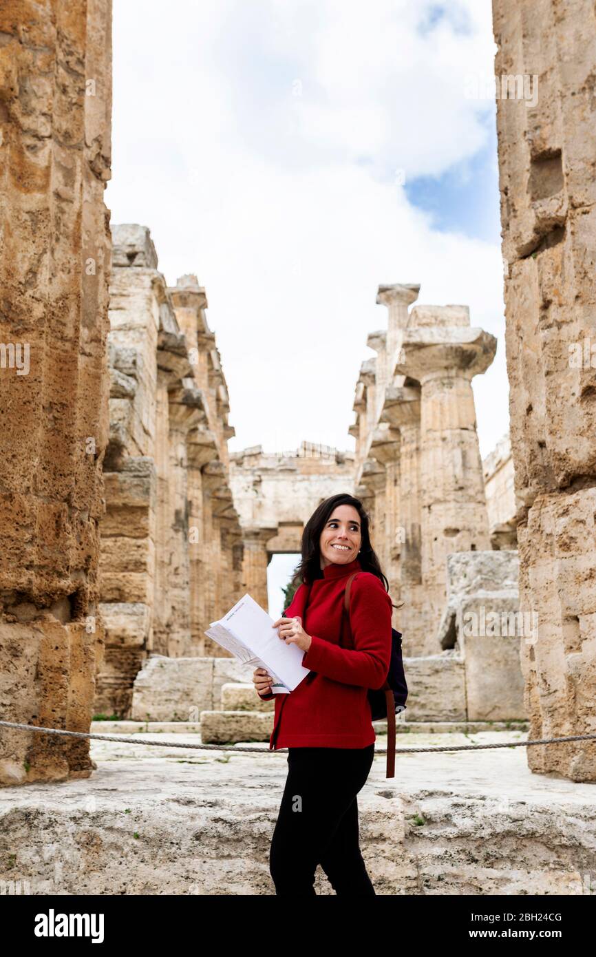 Female tourist walking through the ruins of Paestum, Italy Stock Photo