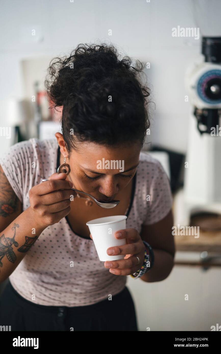 Woman working in a coffee roastery tasting product Stock Photo Alamy