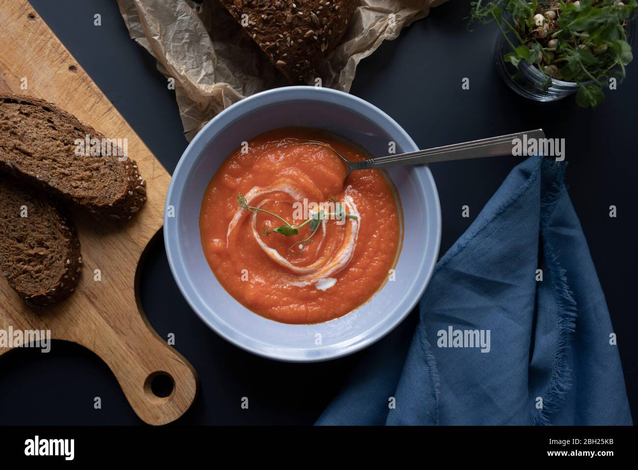 Brown bread and bowl of pumpkin-carrot soup Stock Photo