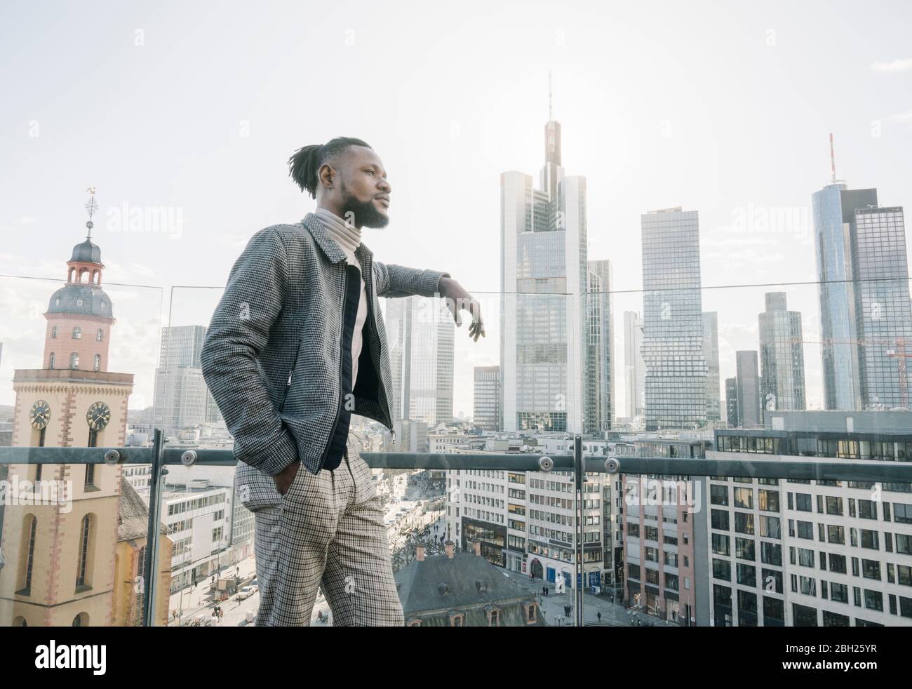 Stylish man on observation terrace looking at skycraper view, Frankfurt, Germany Stock Photo