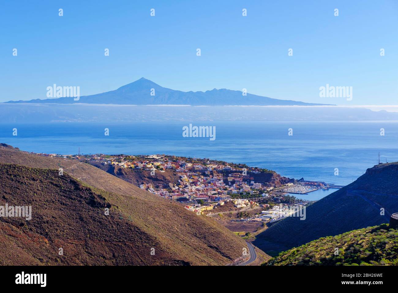 Spain, Province of Santa Cruz de Tenerife, San Sebastian de La Gomera, Coastal town with Tenerife island in distant background Stock Photo