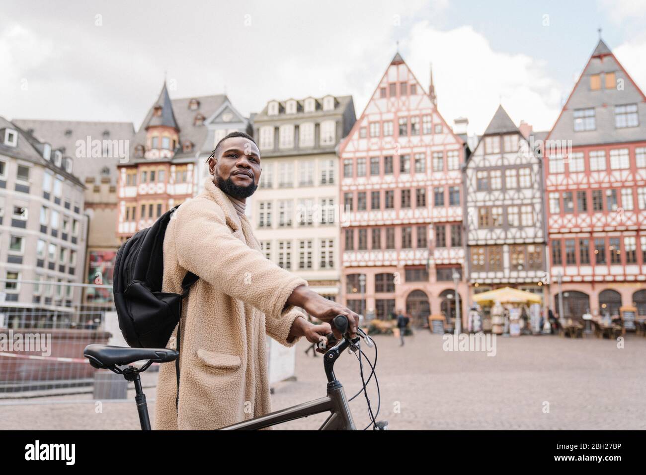 Portrait of stylish man with a bicycle in old town, Frankfurt, Germany Stock Photo