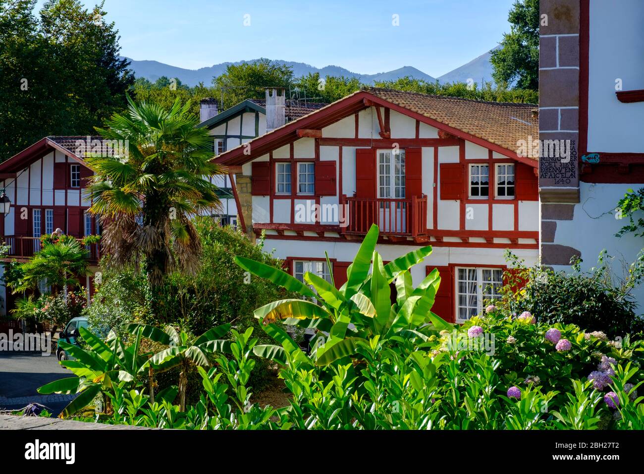 France, Pyrenees-Atlantiques, Ainhoa, Flowering garden plants in front of half-timbered house Stock Photo