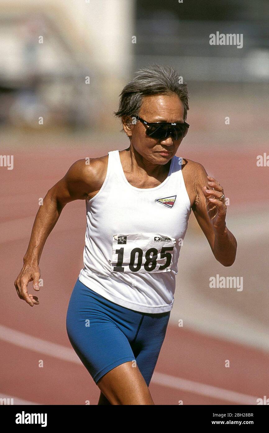 Tucson, Arizona USA, 1997 Elderly Hispanic woman runs in middle