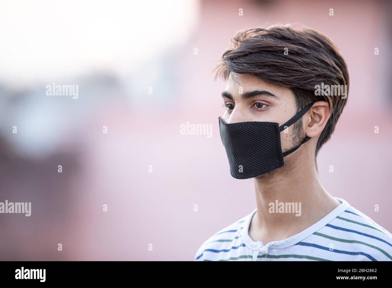 Asian Teenager Boy with mask of face during Lock down  of covid-19 or coronavirus infection Stock Photo