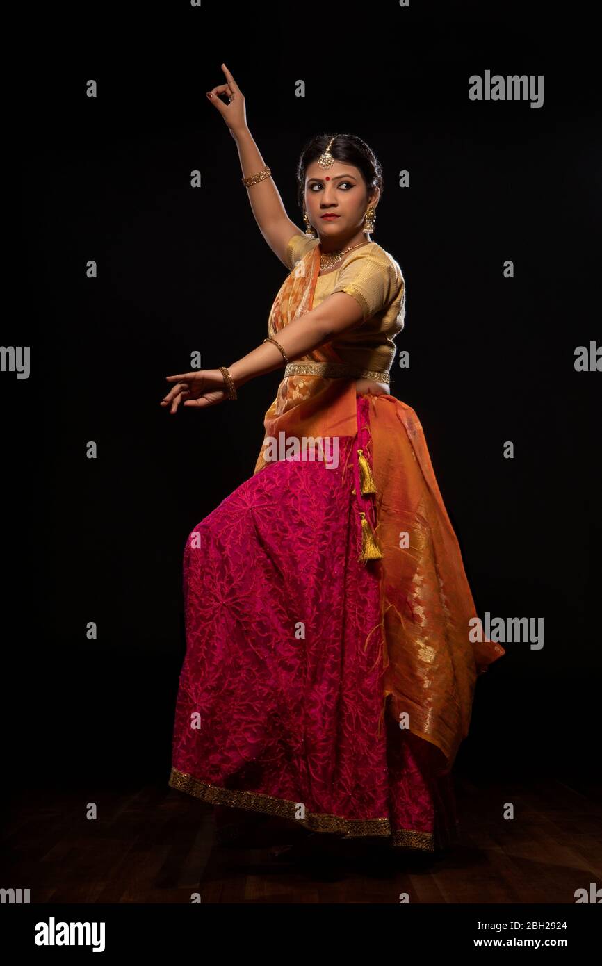 Kathak dancer performing in front of a dark background Stock Photo - Alamy