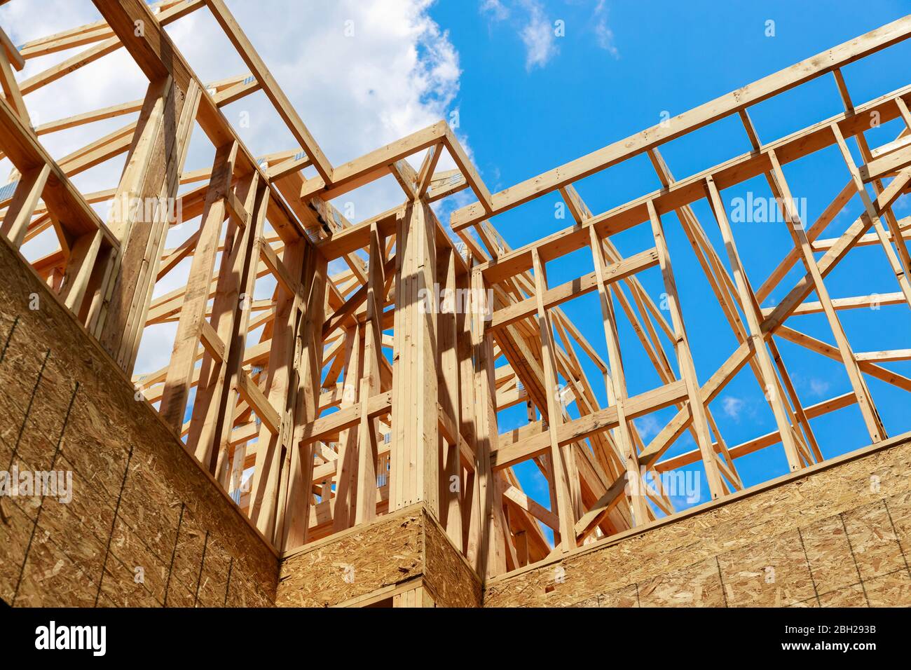 New construction frame home building under construction at sun day Stock Photo