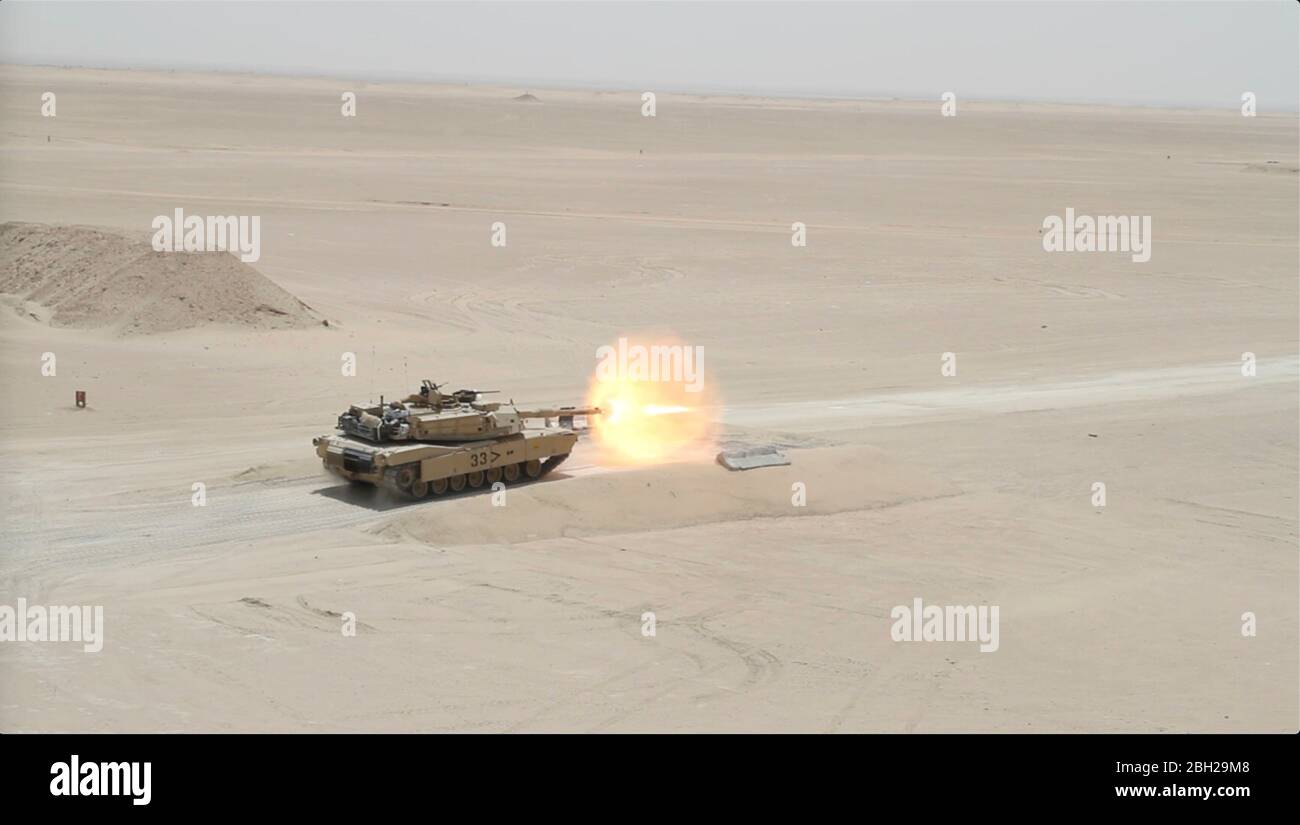 U.S. Army soldiers with the 30th Armored Brigade Combat Team fire a shell from a M1A2 Abrams tank canon during proficiency training at Camp Buehring April 22, 2020 in Kuwait. Stock Photo