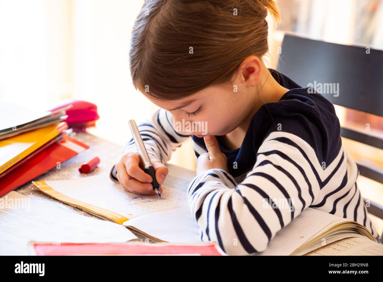 Girl doing homework Stock Photo