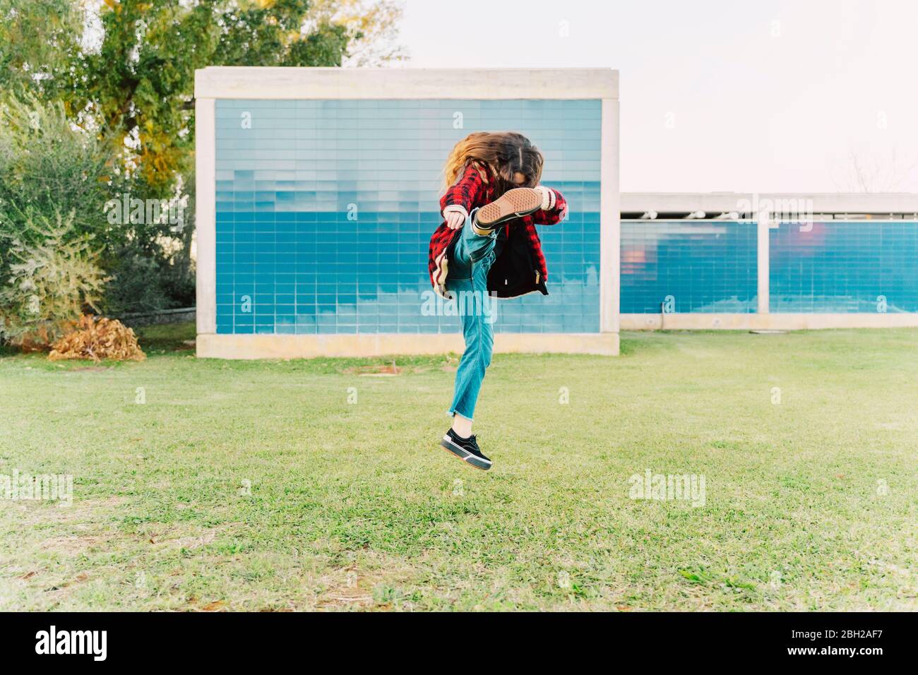 Teenage girl practising self-defence on a meadow Stock Photo