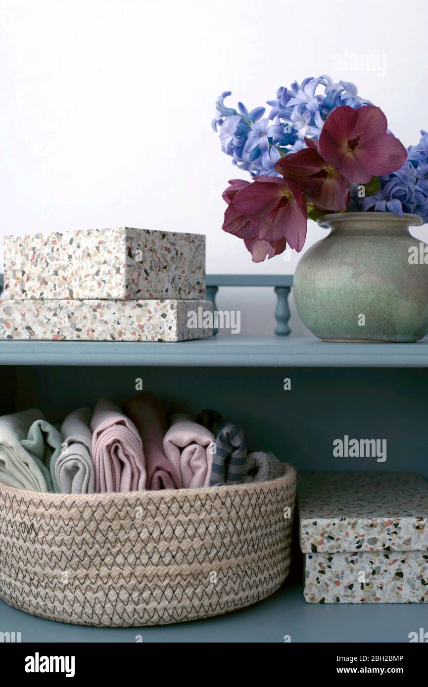 Basket with towels, potted hyacinths and gift boxes decorated with terrazzo adhesive tape Stock Photo