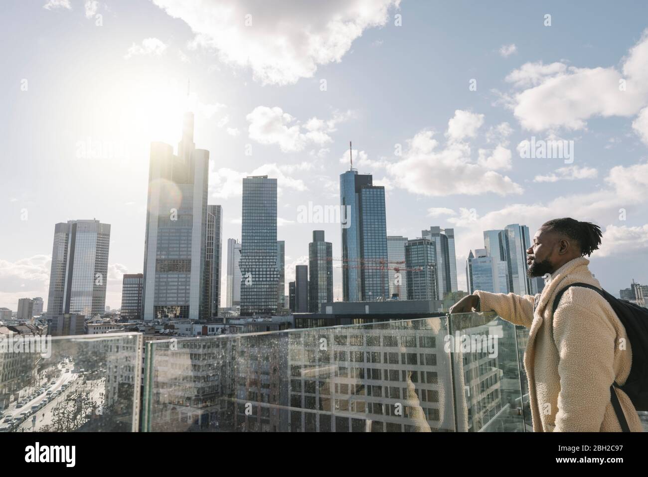 Stylish man on observation terrace looking at skycraper view, Frankfurt, Germany Stock Photo