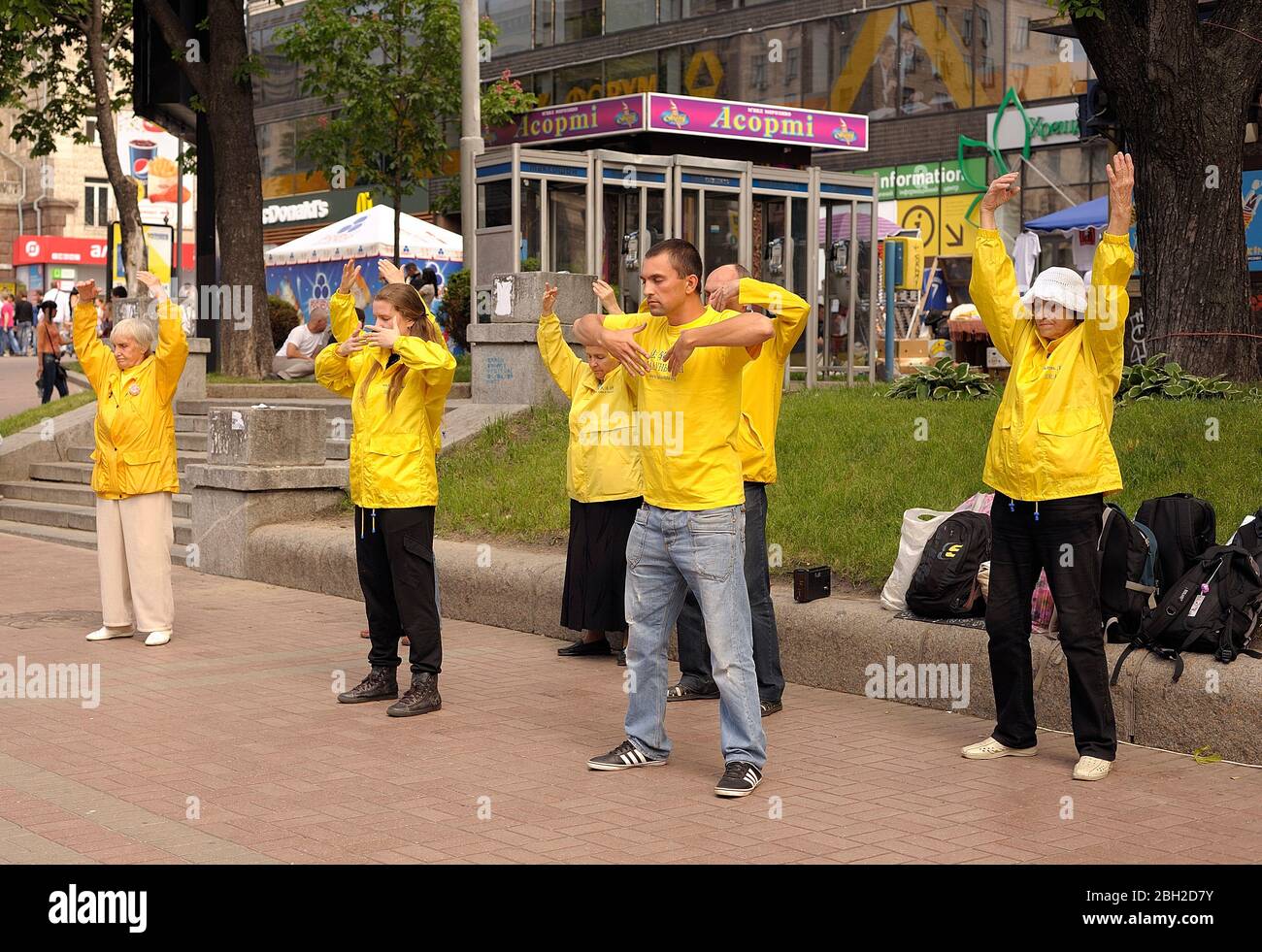 Followers of religious movement Falun dafa doing breathing gymnastics Chi Kung in the street Stock Photo