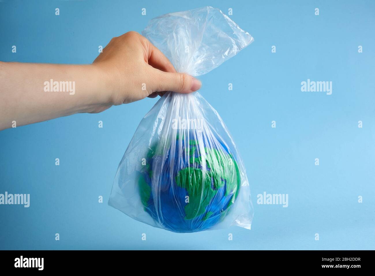 World globe in plastic bag. Environment pollution. Garbage recycling. Pollution problem concept. Stock Photo