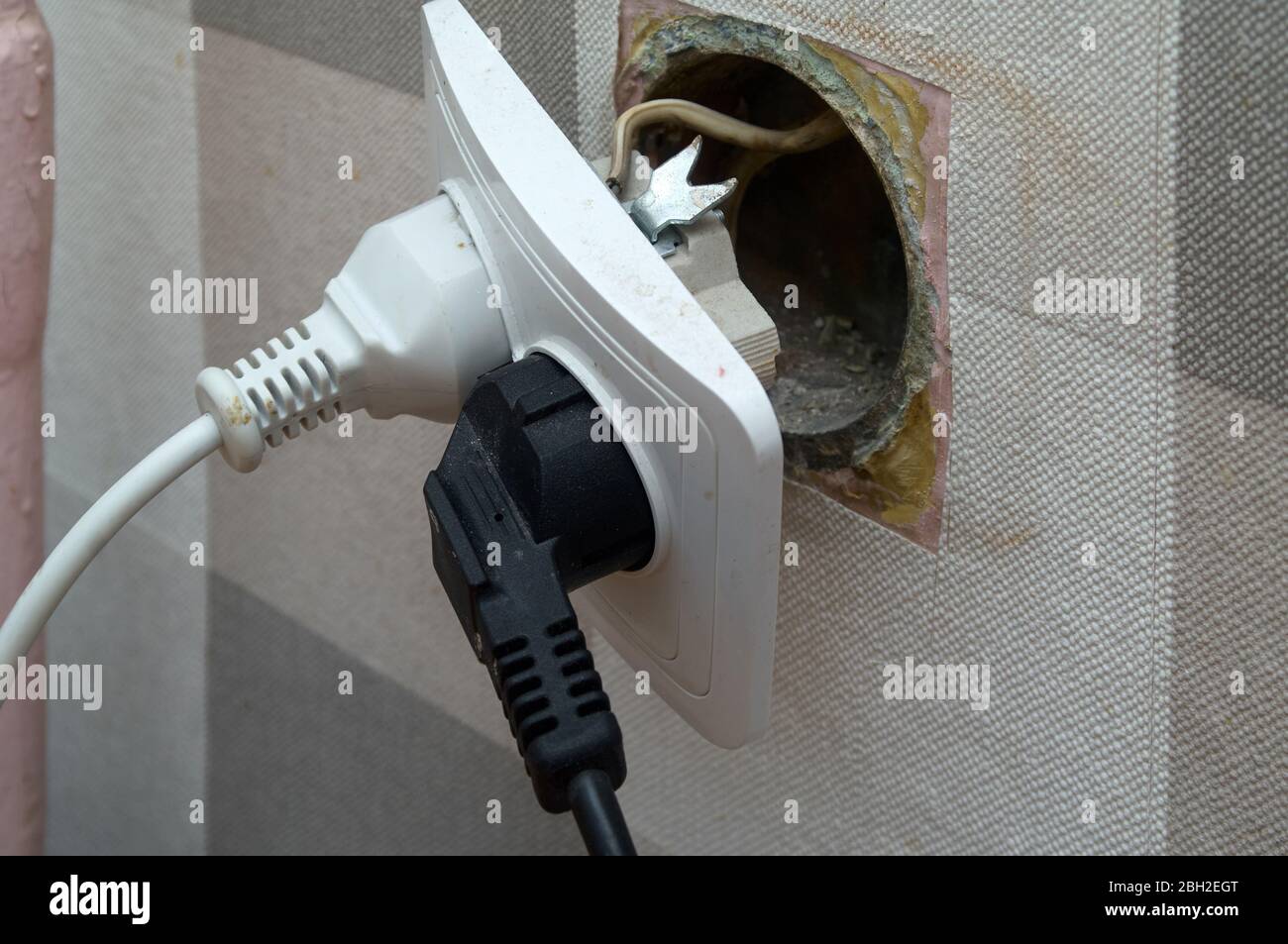Repair of an electrical outlet in a city apartment. Visible insulated