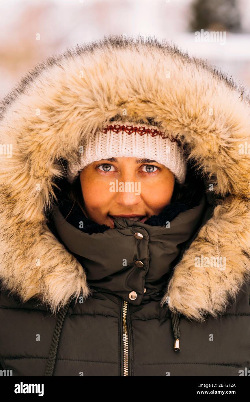 Portrait of smiling woman in winter clothes Stock Photo
