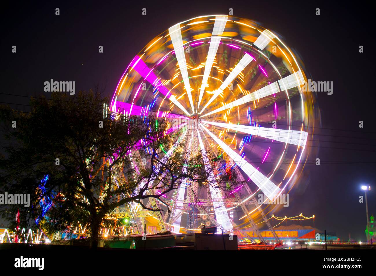 A nighttime view of the Ferris wheel in India with slow sutters speed Stock Photo