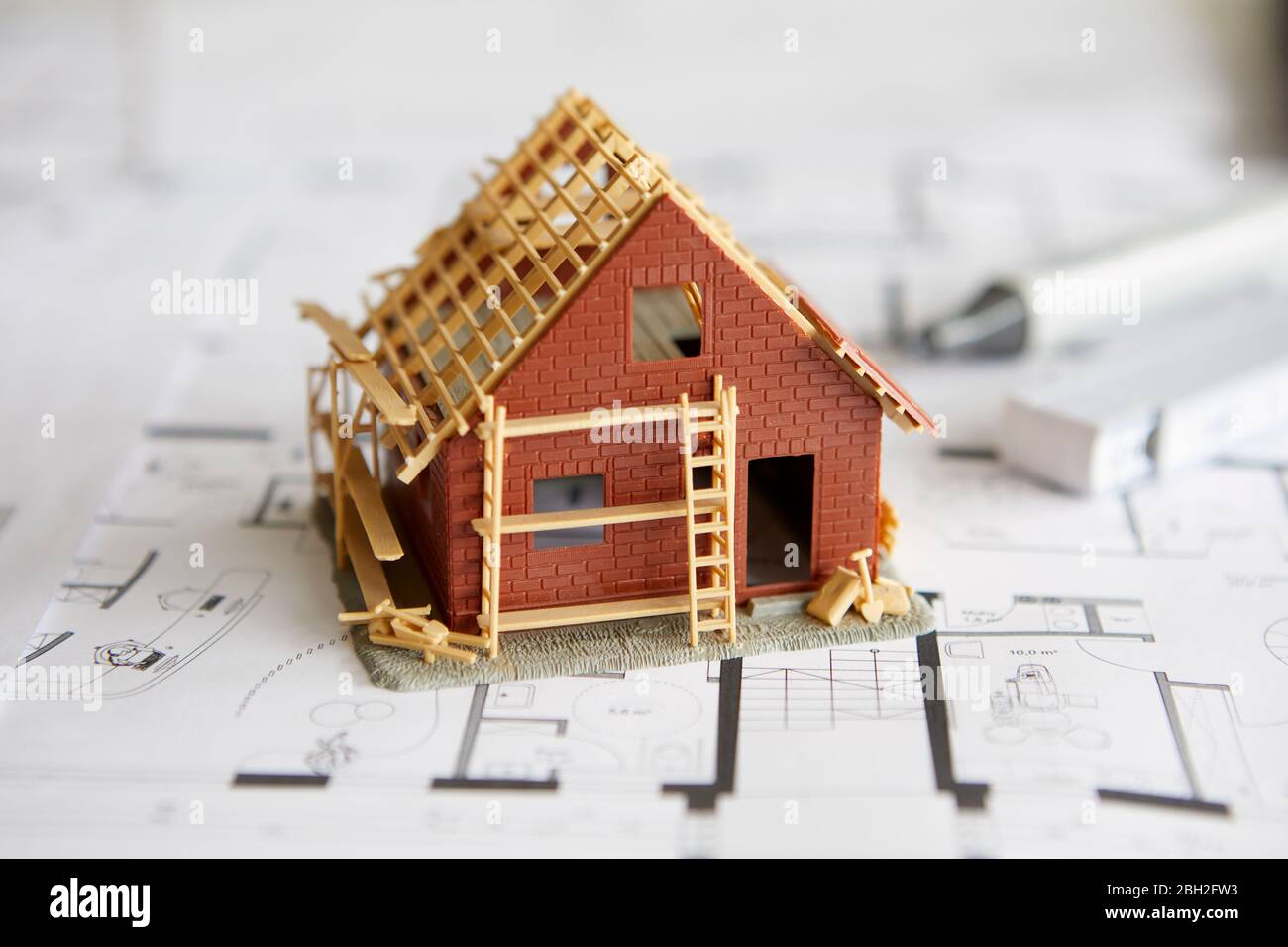 Architecture, model of home ownership on construction plan Stock Photo