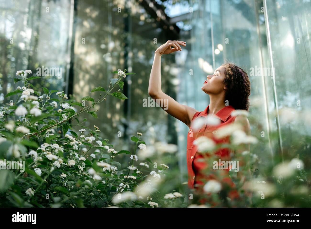 Young woman with eyes closed in an urban garden Stock Photo - Alamy
