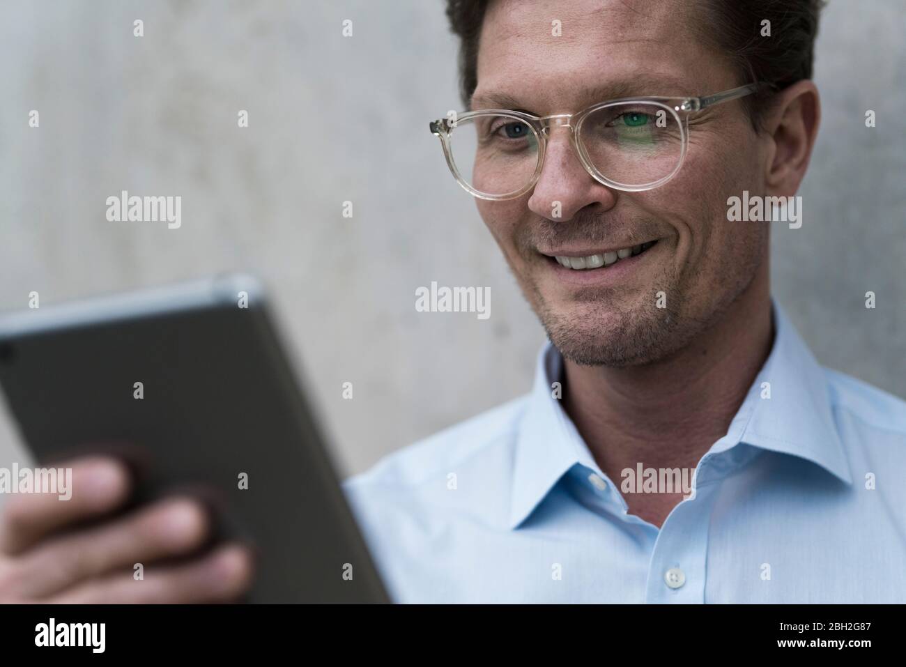 Confident businessman using digital tablet Stock Photo