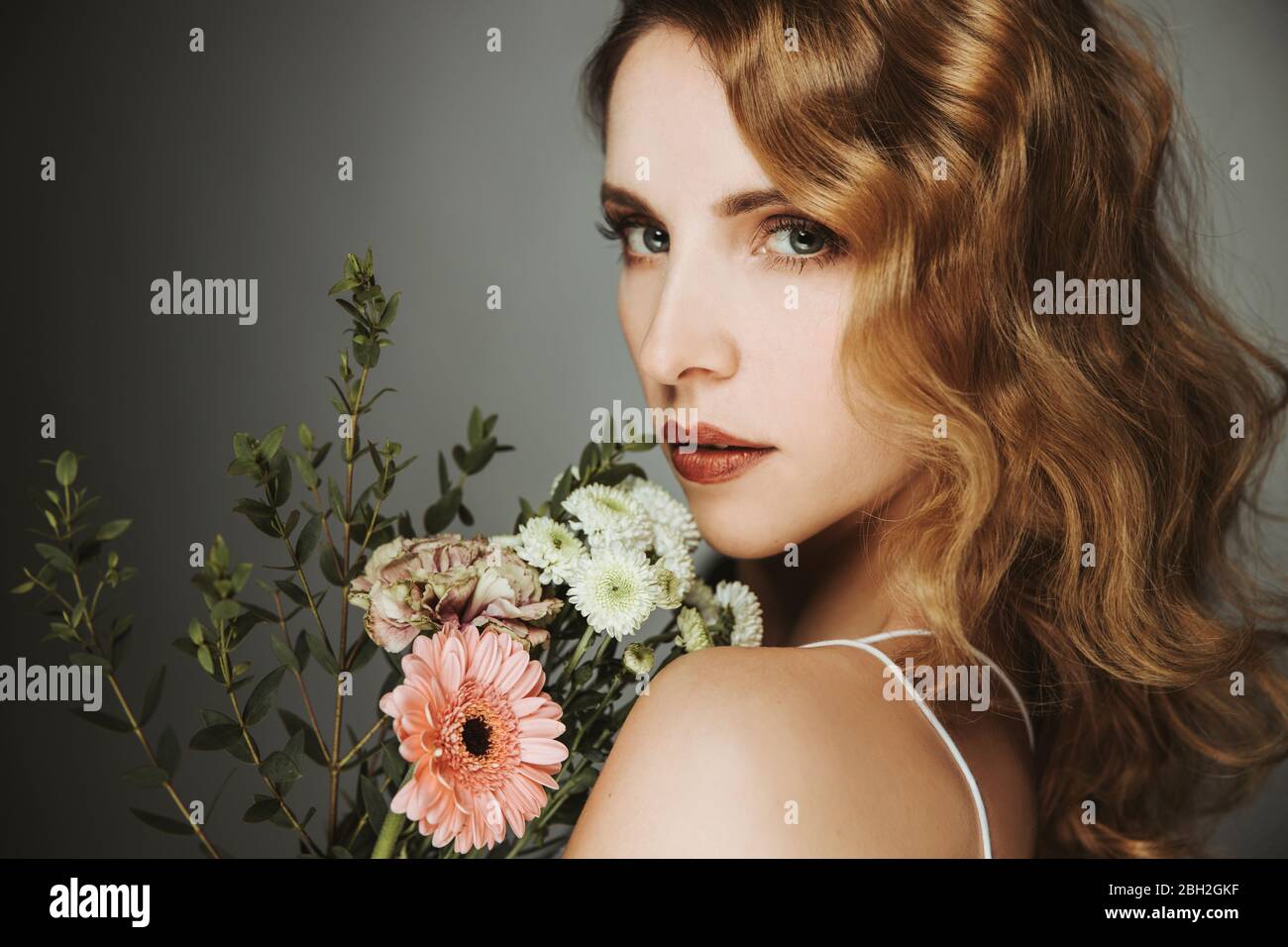 beautiful woman holding bunch of flowers, portrait Stock Photo - Alamy