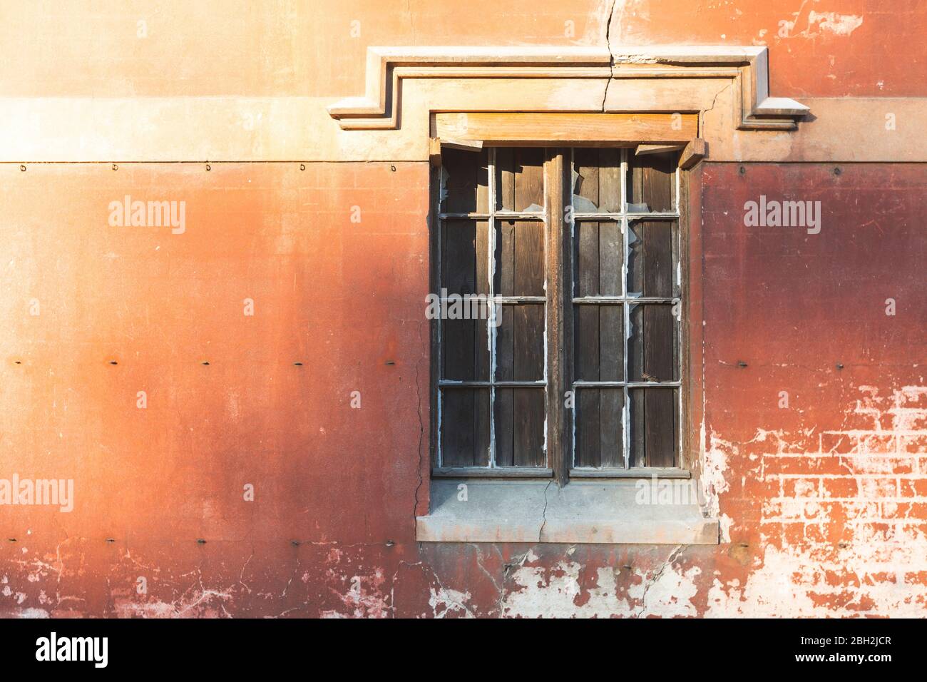 Shuttered window in old brick wall Stock Photo