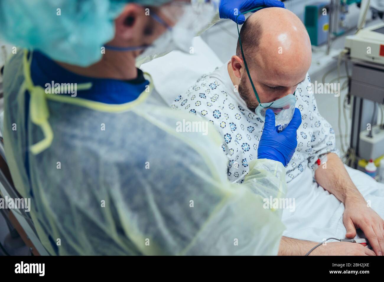 Doctor giving artificial respiration to patient in emergency care unit of a hospital Stock Photo