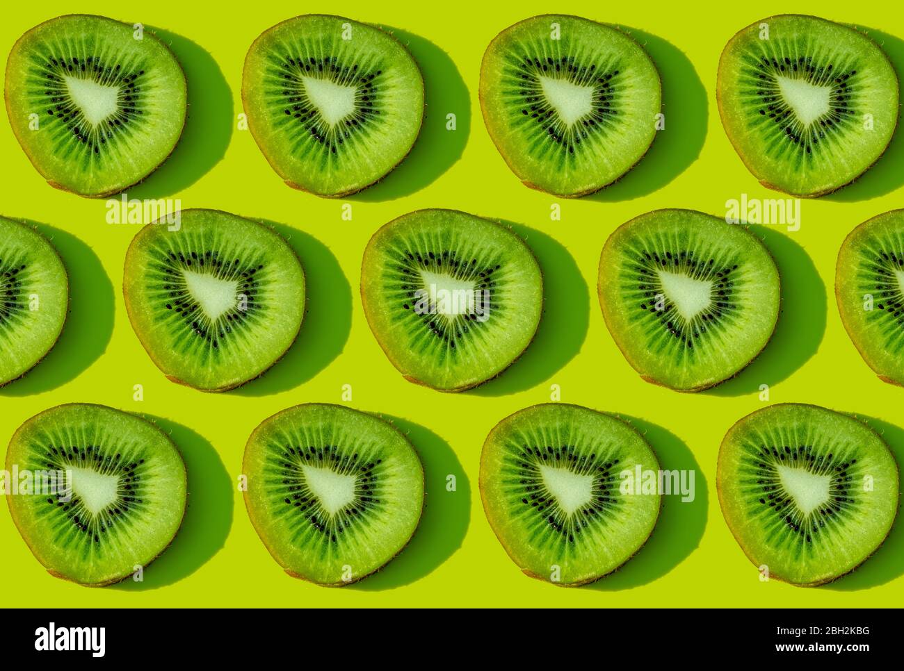 Kiwi fruit pattern on green background Stock Photo