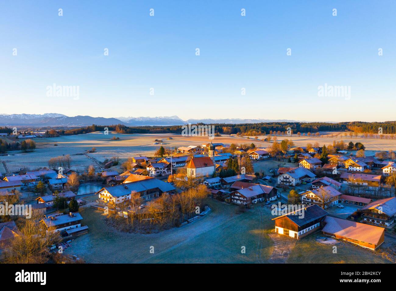 Germany, Bavaria, Lochen, Drone view of clear sky over countryside village at dawn Stock Photo
