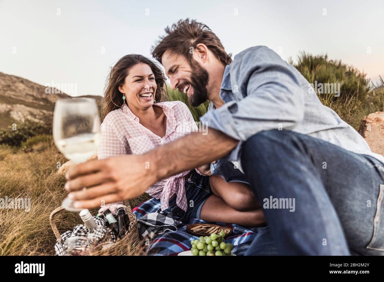 Affectionate couple having a picnic in the countryside Stock Photo