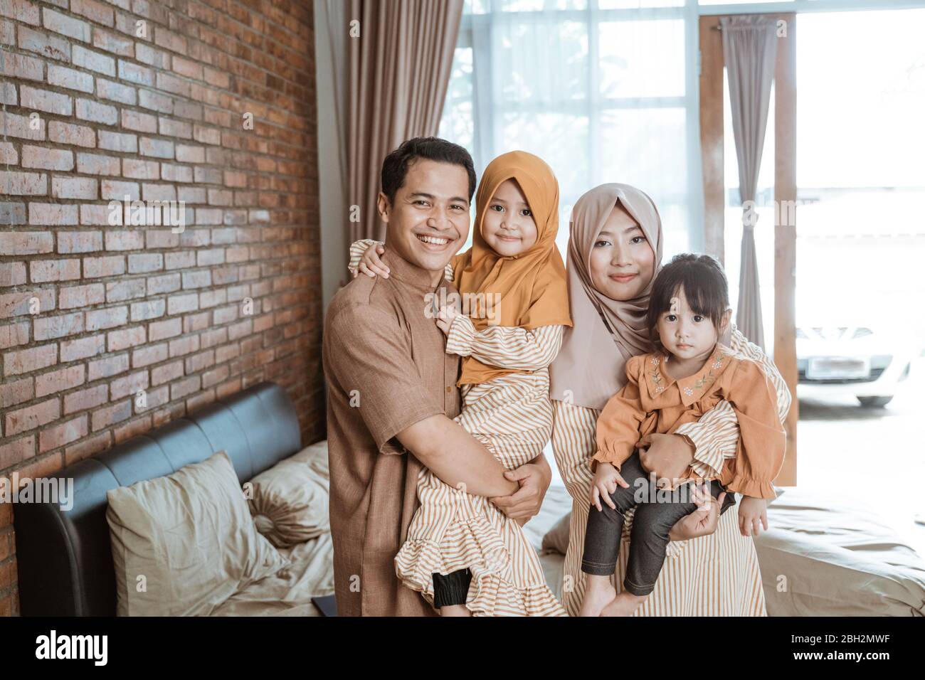 beautiful muslim family smiling to camera. ramadan concept at home Stock Photo