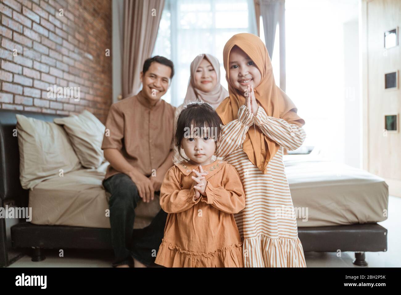 happy smile kid muslim with parent on ramadan kareem month Stock Photo