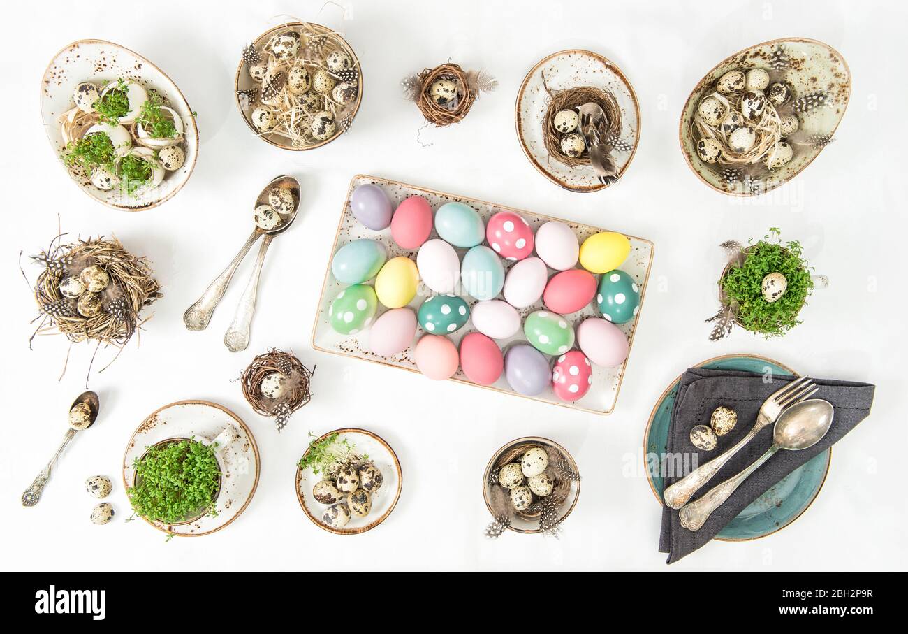Easter flat lay. Festive table place setting decoration with colored eggs Stock Photo