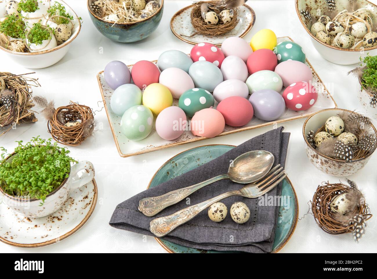 Easter decoration with colored eggs. Festive table place setting Stock Photo